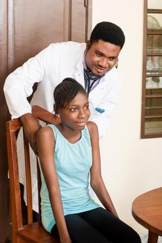 doctor examines a patient in his clinic with a stethoscope