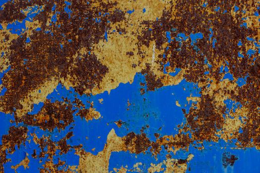 flat texture of rusted steel sheet with yellow and blue peeled off layers of paint