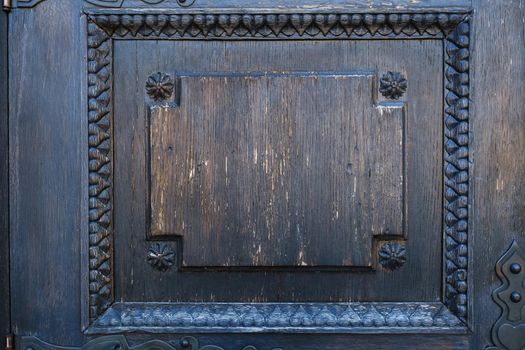 part of an old wooden door with a stained glass pattern.