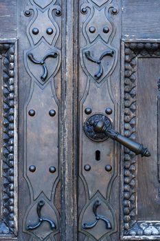 Old metal door handle on the old door.