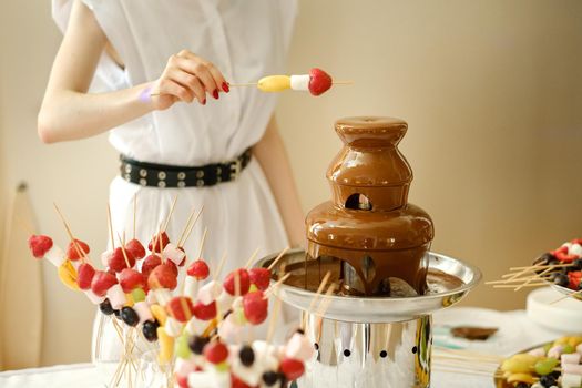 Fondue with a chocolate fountain and sweets for it.Sweet theme.
