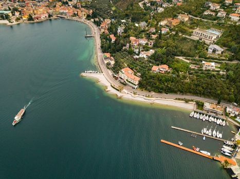 Top view of Lake Lago di Garda and the village of Torbole, alpine scenery. Italy.