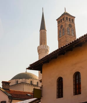 View of the Gazi Husrev-bey minaret and the Clock tower called Sahat Kula in Sarajevo