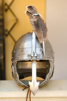 An ancient knight's helmet with a feather .Medieval concept.