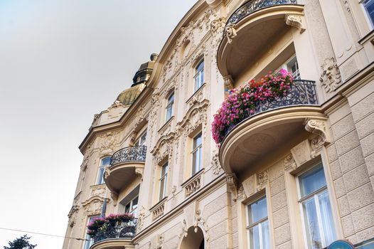 Balconies with flowers in an old house on the street of the city of BRNO .Czech.