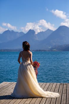 an unusual elongated wedding bouquet in the hands of the bride.