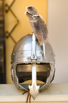 An ancient knight's helmet with a feather .Medieval concept.