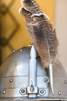 An ancient knight's helmet with a feather .Medieval concept.