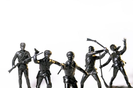 Vintage toy black soldiers isolated on white background.