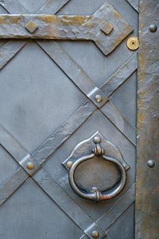 Old metal door handle on the old door.