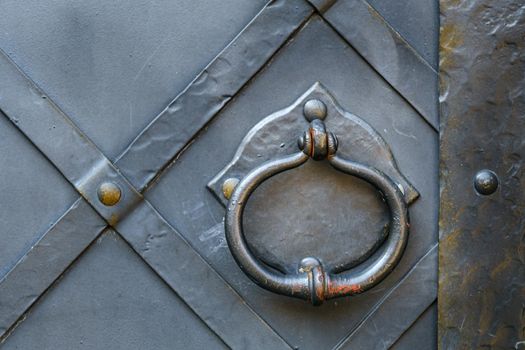 Old metal door handle on the old door.
