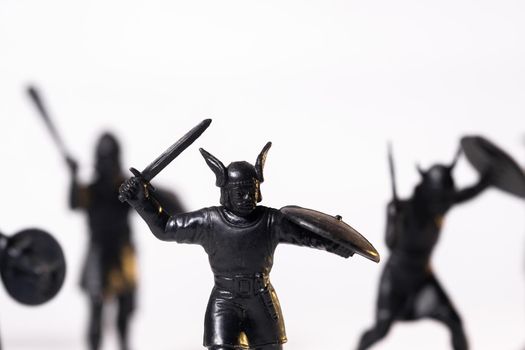 Vintage toys black Viking soldiers isolated on white background.