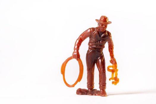 Vintage toy brown cowboy isolated on white background.