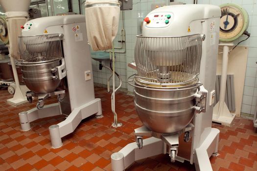 The process of making cookie dough in an industrial kneading machine at the factory.