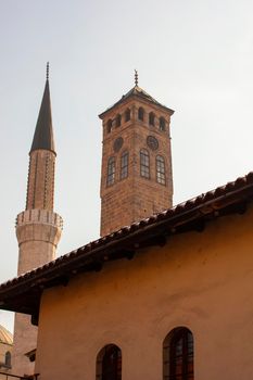 Vew of the Gazi Husrev-bey minaret and the Clock tower called Sahat Kula in Sarajevo