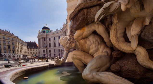 Fontain with sculpture of the Hofburg imperial palace in Michaelerplatz square, Vienna