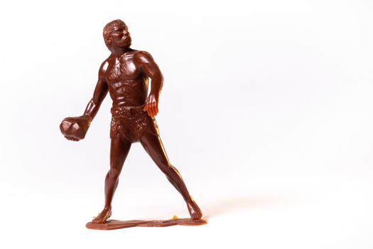 Large toy figures of primitive people on a white background.