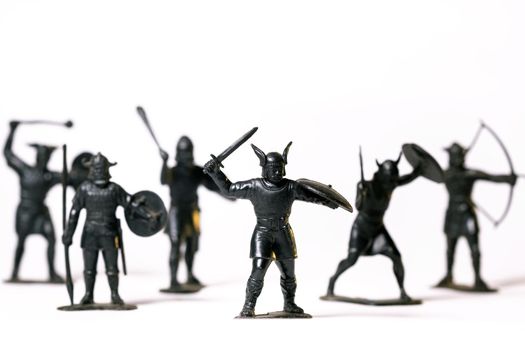 Vintage toys black Viking soldiers isolated on white background.
