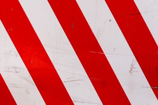 faded red and white diagonal stipes on flat steel sheet - caution road sign