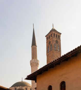 View of the Gazi Husrev-bey minaret and the Clock tower called Sahat Kula in Sarajevo