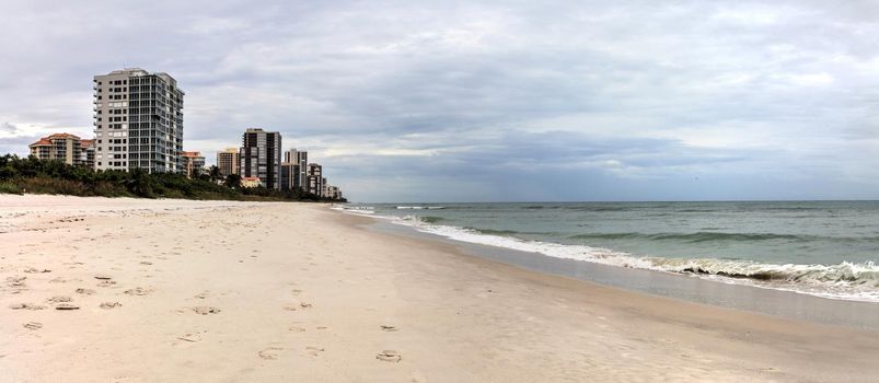 Dreary Grey sky over the beach of Park Shore Beach in Naples, Florida