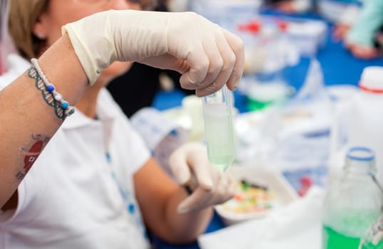 Chemist is holding test tube in a science laboratory