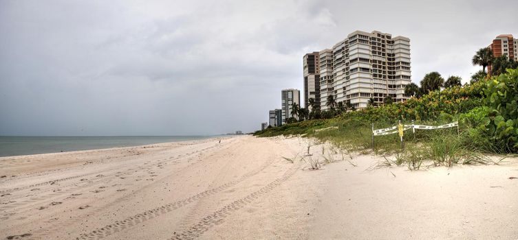 Dreary Grey sky over the beach of Park Shore Beach in Naples, Florida