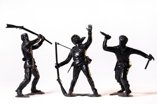 Vintage toy black soldiers isolated on white background.