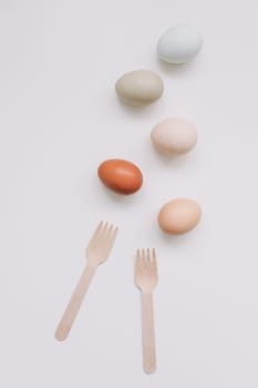 Chicken eggs of natural shades and colors a white background. Healthy organic food, natural farmer's products concept. Happy Easter background. Selective focus.