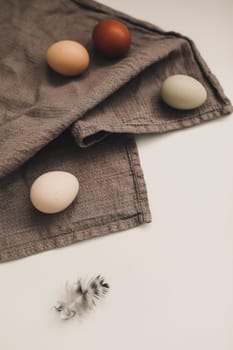 Chicken eggs of natural shades and colors a white background. Healthy organic food, natural farmer's products concept. Happy Easter background. Selective focus.