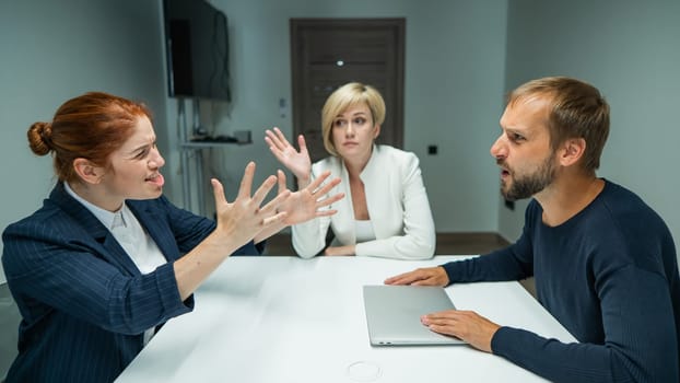 Blond, red-haired woman and bearded man in suits in the office. Business people are swearing during negotiations in the conference room
