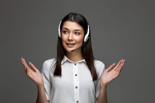 friendly smiling woman with headset is consulting clients online. Call center, business people concept