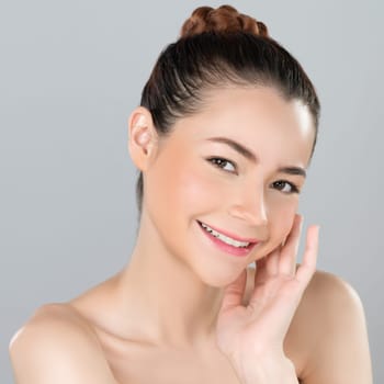 Glamorous woman portrait with perfect smooth pure clean skin with soft cosmetic makeup in isolated background. Beauty hand gesture with expressive facial expression for skincare product or spa ad.