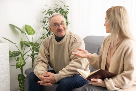 Close up anxious serious old man listening to female doctor at meeting in hospital, therapist physician consulting mature patient about disease, treatment, elderly generation healthcare concept.