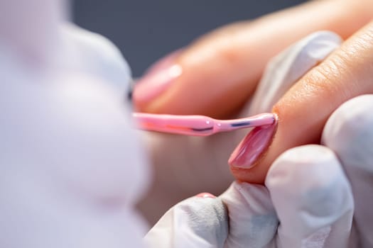 A woman using the services of a beauty salon.Preparation of the nail plate for further cosmetic procedures. Maintaining the principles of hygiene in the beauty salon. Close-up on the hands of a beauty salon client.