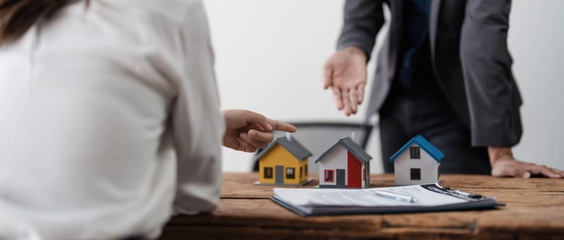 Sealing a deal. Asian people business real estate agent with client consulting and discussing at office desk. talking with contract agreement before signing...