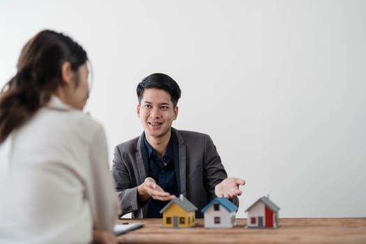 Sealing a deal. Asian people business real estate agent with client consulting and discussing at office desk. talking with contract agreement before signing...