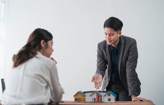 Sealing a deal. Asian people business real estate agent with client consulting and discussing at office desk. talking with contract agreement before signing...