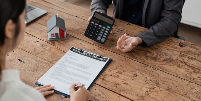 Sealing a deal. Asian people business real estate agent with client consulting and discussing at office desk. talking with contract agreement before signing. Sign a contract..