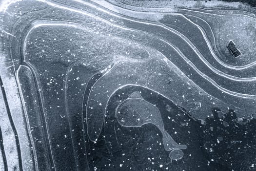 Textured ice background with white snow curves on the surface, and an air bulb in the shape of a whale. The photo showcases the beauty and intricacy of nature's designs in a winter landscape. High quality photo