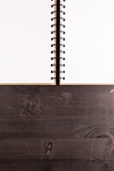 Top view of opened notebook on wooden background