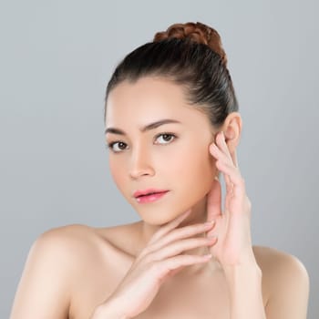 Glamorous woman portrait with perfect smooth pure clean skin with soft cosmetic makeup in isolated background. Beauty hand gesture with expressive facial expression for skincare product or spa ad.