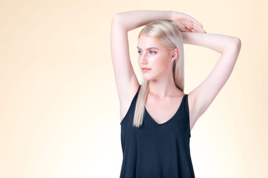 Personable woman lifting her armpit showing hairless hygiene underarm as beauty posing for cleanliness and perfect smooth skincare treatment in isolated background. Hair removal and epilation concept.