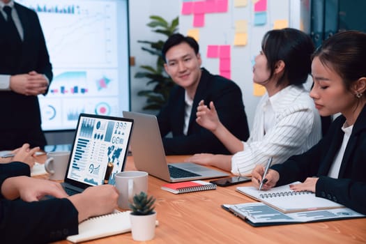 Confidence and asian businessman give presentation on financial analyzed by business intelligence in dashboard report to other people in board room meeting to promote harmony in workplace.