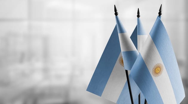 A small Argentina flag on an abstract blurry background.