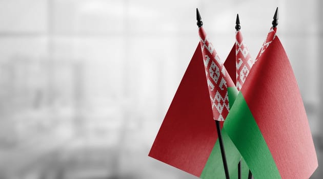 A small Belarus flag on an abstract blurry background.