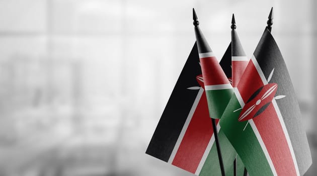 Small flags of the Kenya on an abstract blurry background.