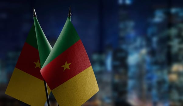 Small flags of the Cameroon on an abstract blurry background.