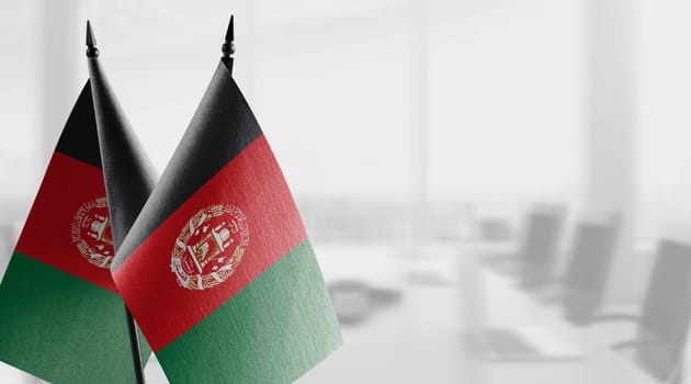 A small Afghanistan flag on an abstract blurry background.