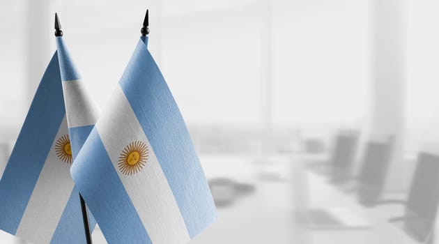 A small Argentina flag on an abstract blurry background.